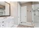 Beautiful bathroom featuring a vanity with a marble countertop and framed mirror, and a glass-door shower at 8651 S De Gaulle Ct, Aurora, CO 80016