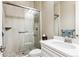 This bathroom features a frameless glass shower door and a white vanity with a quartz countertop at 8651 S De Gaulle Ct, Aurora, CO 80016