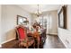 Elegant dining room featuring a set dining table, stylish decor, and ample natural light at 8651 S De Gaulle Ct, Aurora, CO 80016