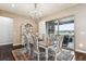 Elegant dining room with a chandelier, area rug, and access to the outdoor patio at 8651 S De Gaulle Ct, Aurora, CO 80016