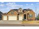 Charming brick home with a three-car garage, well-maintained lawn, and inviting curb appeal at 8651 S De Gaulle Ct, Aurora, CO 80016