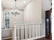 Upstairs hallway with chandelier and stairway at 8651 S De Gaulle Ct, Aurora, CO 80016