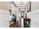 Elegant entry with hardwood floors, chandelier, and detailed trim work at 8651 S De Gaulle Ct, Aurora, CO 80016