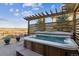 Outdoor hot tub on a stone patio with a wooden pergola overhead, offering relaxation and privacy at 8651 S De Gaulle Ct, Aurora, CO 80016