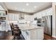 Spacious kitchen with granite countertops, white cabinets, and stainless steel appliances at 8651 S De Gaulle Ct, Aurora, CO 80016