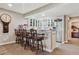 Kitchen bar with stylish barstools and glass front cabinets at 8651 S De Gaulle Ct, Aurora, CO 80016