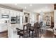 Open concept kitchen with a large island, stainless steel appliances and hardwood floors at 8651 S De Gaulle Ct, Aurora, CO 80016