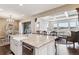 Kitchen with a view to the living room, large island and hardwood floors at 8651 S De Gaulle Ct, Aurora, CO 80016