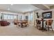 Spacious living room featuring a table with chairs, leather sofas, and large windows for natural light at 8651 S De Gaulle Ct, Aurora, CO 80016