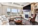 Spacious living room features a fireplace, large windows with scenic views, and coffered ceilings at 8651 S De Gaulle Ct, Aurora, CO 80016