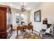 Home office with a desk, an area rug, a lamp, and a comfortable chair at 8651 S De Gaulle Ct, Aurora, CO 80016