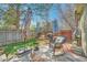 Relaxing backyard space with a comfortable wicker chair and a barbecue grill at 18578 E Whitaker Cir # A, Aurora, CO 80015