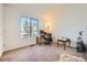 Comfortable bedroom with large window allowing for natural light and neutral carpet at 18578 E Whitaker Cir # A, Aurora, CO 80015