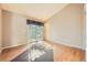 Bright bedroom with sliding glass door and hardwood floors, offering great natural light at 18578 E Whitaker Cir # A, Aurora, CO 80015
