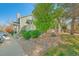 Exterior view of townhomes with beautiful rock landscaping, healthy foliage and dedicated parking at 18578 E Whitaker Cir # A, Aurora, CO 80015