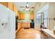 Well-lit kitchen with wooden cabinetry, black appliances, and a large window creating a bright and inviting space at 18578 E Whitaker Cir # A, Aurora, CO 80015