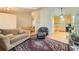 Open-concept living room flowing into a kitchen, with hardwood floors and tall vaulted ceilings for a spacious feel at 18578 E Whitaker Cir # A, Aurora, CO 80015