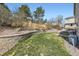 Landscaped backyard featuring grass area and an outdoor living space with furniture at 10065 Cairns Ct, Highlands Ranch, CO 80130