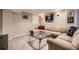 Finished basement with a large sectional sofa, glass coffee table and sports memorabilia at 10065 Cairns Ct, Highlands Ranch, CO 80130