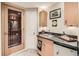 Basement bar area with a wine cellar, wet bar with granite counter and mini fridge at 10065 Cairns Ct, Highlands Ranch, CO 80130
