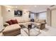Finished basement with a large sectional sofa, glass coffee table and sports memorabilia at 10065 Cairns Ct, Highlands Ranch, CO 80130
