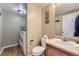 Bathroom with laundry facilities; features a toilet, sink, and storage at 10065 Cairns Ct, Highlands Ranch, CO 80130