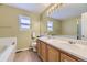 Bathroom with double sinks, a large mirror, and updated fixtures at 10065 Cairns Ct, Highlands Ranch, CO 80130