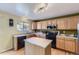 Bright kitchen features an island, modern appliances, and ample cabinet space at 10065 Cairns Ct, Highlands Ranch, CO 80130