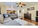 Open-concept living area featuring a comfortable sectional, hardwood floors, and seamless flow to the kitchen and dining areas at 10065 Cairns Ct, Highlands Ranch, CO 80130