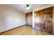 A comfortable bedroom with light walls, wood-look flooring, and a classic wooden door at 1982 E 129Th Dr, Thornton, CO 80241