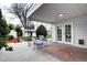 Covered back porch featuring tile accents, patio chairs, and a view of the well-maintained backyard at 2389 Nome St, Aurora, CO 80010