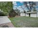 Spacious backyard featuring lush green grass, mature trees, a storage shed, and well-kept landscaping at 2389 Nome St, Aurora, CO 80010
