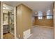 Basement with a connecting bath featuring glass shower doors, wood look tile, and a unique modern vanity at 2389 Nome St, Aurora, CO 80010