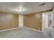 Spacious basement with neutral carpet and light fixtures; ready for versatile use and personalization at 2389 Nome St, Aurora, CO 80010
