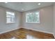 Bright bedroom with hardwood floors and natural light from two windows at 2389 Nome St, Aurora, CO 80010