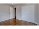 Bedroom with hardwood floors features a closet and easy access to an adjoining room at 2389 Nome St, Aurora, CO 80010