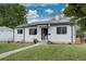 A charming home with a well-kept lawn, solar panels, and inviting curb appeal at 2389 Nome St, Aurora, CO 80010