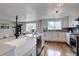 Bright, modern kitchen with white cabinets, a farmhouse sink, and open layout at 2389 Nome St, Aurora, CO 80010