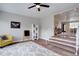 Open living area with white shelving, modern ceiling fan, and access to the rest of the home at 2389 Nome St, Aurora, CO 80010