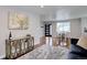 Cozy living room with a decorative console, plush rug, and view of the dining area at 2389 Nome St, Aurora, CO 80010