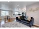 Bright open-concept living space with stylish sofa, kitchen, and dining area at 2389 Nome St, Aurora, CO 80010