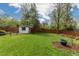 Large, grassy backyard with garden shed and wood fence at 8390 E Davies Pl, Centennial, CO 80112