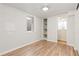 Minimalist basement bedroom with wood-look floors, a window for natural light, and an adjacent bathroom for convenience at 8390 E Davies Pl, Centennial, CO 80112