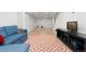 Finished basement with vinyl flooring, a cozy seating area, and a large TV, perfect for relaxation and entertainment at 8390 E Davies Pl, Centennial, CO 80112