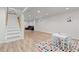Finished basement featuring a vibrant ' area, vinyl flooring, and stairs leading to the upper level at 8390 E Davies Pl, Centennial, CO 80112