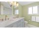 Bathroom with a double vanity, granite counters, gold hardware, and a walk-in shower at 8390 E Davies Pl, Centennial, CO 80112