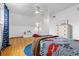 Charming bedroom showcasing a car-themed design, complemented by hardwood floors and a light-filled window view at 8390 E Davies Pl, Centennial, CO 80112