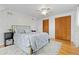 Bedroom featuring neutral tones, wood floors, area rug, ceiling fan and closet space at 8390 E Davies Pl, Centennial, CO 80112