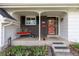 Close-up of the inviting front porch with a black brick facade and a cozy seating area at 8390 E Davies Pl, Centennial, CO 80112