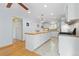 Open kitchen with a large island, white cabinets, stainless steel appliances, and hardwood floors at 8390 E Davies Pl, Centennial, CO 80112